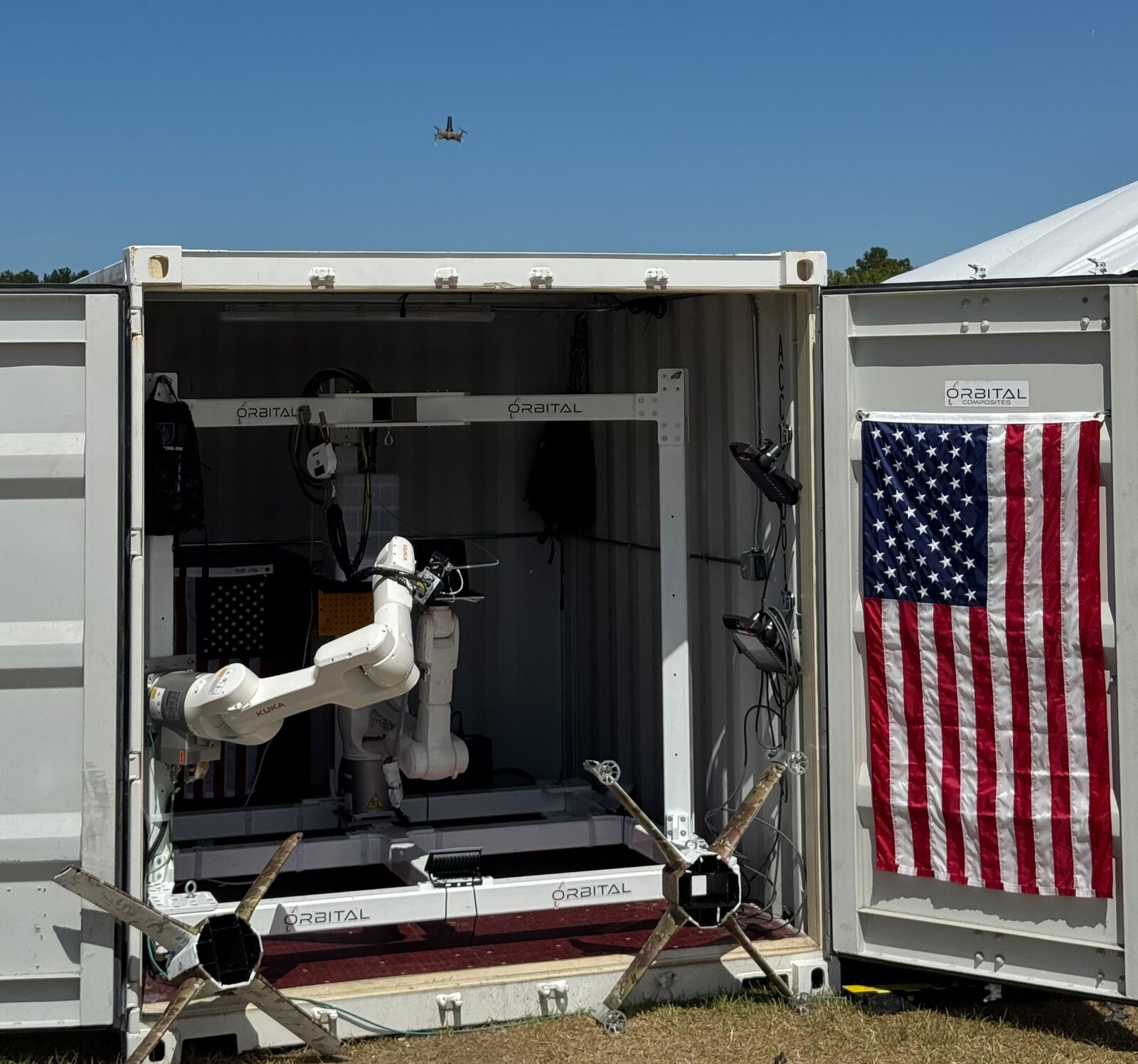 Orbital cell deployed in the field, with composite drone and camouflaged airframe