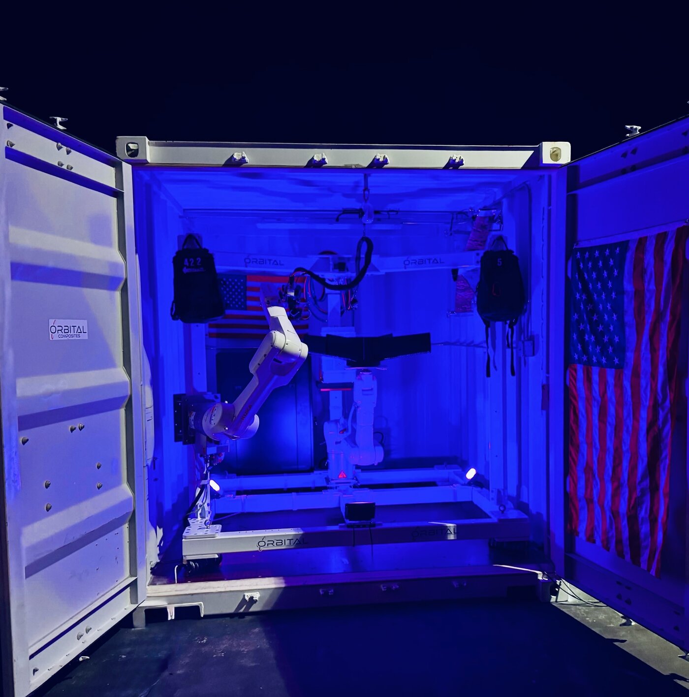 Orbital S cell — 10-foot production unit with KUKA robotic arms printing a composite drone airframe